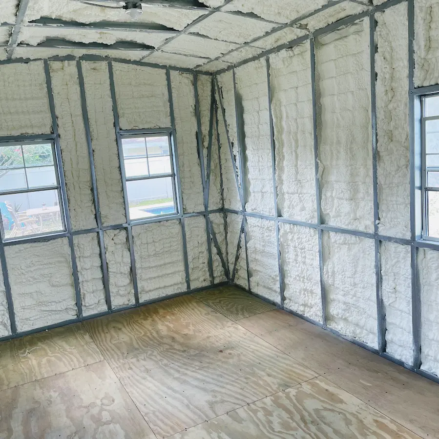 Closed-cell spray foam insulation applied to wall cavities in a residential project in Kermit